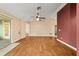 Spacious living room featuring hardwood floors and sliding door access to the lanai at 9001 Sw 91St Cir, Ocala, FL 34481