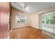 Open living room with hardwood floors and sliding doors leading to the outside at 9001 Sw 91St Cir, Ocala, FL 34481