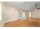 Large living room showcasing hardwood floors and sliding glass doors to an outdoor living space at 9001 Sw 91St Cir, Ocala, FL 34481