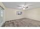 Main bedroom with carpeted flooring, sliding door and natural light at 9001 Sw 91St Cir, Ocala, FL 34481