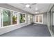 Bright sun room featuring large windows, ceiling fans and access to outdoors at 9001 Sw 91St Cir, Ocala, FL 34481