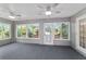Spacious sunroom featuring large windows and ceiling fans at 9001 Sw 91St Cir, Ocala, FL 34481
