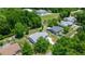 An aerial perspective shows a single-Gathering house with a spacious yard, nestled in a neighborhood with mature trees at 9021 Sw 108Th Pl, Ocala, FL 34481