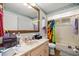 Bathroom featuring a large vanity, a framed mirror, and a shower-tub combo with a bright curtain at 9021 Sw 108Th Pl, Ocala, FL 34481