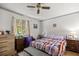 Comfortable bedroom featuring a ceiling fan and natural light streaming through the window at 9021 Sw 108Th Pl, Ocala, FL 34481