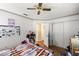 Bedroom featuring wood-look floors, closet and doorway, and ceiling fan at 9021 Sw 108Th Pl, Ocala, FL 34481