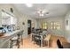 Light and airy dining room with wood floors, a ceiling fan, and a dining table and chairs at 9021 Sw 108Th Pl, Ocala, FL 34481