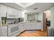 Efficient kitchen with white appliances, wood floors, and plenty of countertop space at 9021 Sw 108Th Pl, Ocala, FL 34481
