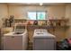 Laundry room with modern washer and dryer, and shelving for storage at 9021 Sw 108Th Pl, Ocala, FL 34481