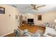 The living room features wood floors, a ceiling fan, and a view into an office area at 9021 Sw 108Th Pl, Ocala, FL 34481