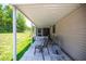Covered porch with tile flooring and comfortable seating area, ideal for relaxation and enjoying the view at 9021 Sw 108Th Pl, Ocala, FL 34481