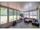 Relaxing sunroom with lots of natural light, windows, tile floor, and comfortable seating area at 9021 Sw 108Th Pl, Ocala, FL 34481