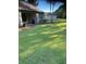 Expansive backyard featuring lush green grass, a covered patio, and a tranquil, private setting at 9170 Sw 65Th Loop, Ocala, FL 34481