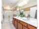 Bright bathroom boasts a double sink vanity, a glass enclosed shower, and neutral color scheme at 9170 Sw 65Th Loop, Ocala, FL 34481