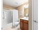 Cozy bathroom featuring a shower with a glass door and a wooden vanity at 9170 Sw 65Th Loop, Ocala, FL 34481