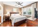 Relaxing bedroom with wood floors, a queen-size bed, and a window with shutters at 9170 Sw 65Th Loop, Ocala, FL 34481