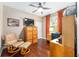 Inviting bedroom features hardwood floors, a ceiling fan, and ample space for a comfortable setup at 9170 Sw 65Th Loop, Ocala, FL 34481
