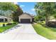 Charming single-story home with a wide driveway, complemented by well-maintained landscaping and mature trees at 9170 Sw 65Th Loop, Ocala, FL 34481