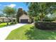 Attractive single-story home features a wide driveway, lush greenery, and appealing curb appeal in a quiet neighborhood at 9170 Sw 65Th Loop, Ocala, FL 34481