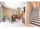 Inviting living room features a brown leather sofa, tile flooring, and staircase at 9170 Sw 65Th Loop, Ocala, FL 34481