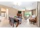 Open-concept living and dining area with tile floors, a ceiling fan, and ample natural light at 9170 Sw 65Th Loop, Ocala, FL 34481