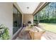 Covered patio with outdoor seating, a grill, and a view of the backyard at 9170 Sw 65Th Loop, Ocala, FL 34481