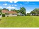 Well-maintained backyard with a large, green lawn and mature trees creating a peaceful and inviting outdoor space at 9266 Sw 91St Cir, Ocala, FL 34481