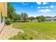 Expansive backyard showcasing a well-manicured lawn and mature trees, offering a serene outdoor setting at 9266 Sw 91St Cir, Ocala, FL 34481