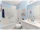 Bathroom features a tub-shower combo with white tile and a single sink vanity at 9266 Sw 91St Cir, Ocala, FL 34481