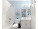 Bathroom with tub and shower, blue walls, and single sink vanity at 9266 Sw 91St Cir, Ocala, FL 34481