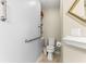 Bathroom with toilet, grab bars, and open shelving for convenient storage at 9266 Sw 91St Cir, Ocala, FL 34481