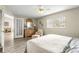 Cozy bedroom featuring wood floors, a ceiling fan, and a comfy sitting area at 9266 Sw 91St Cir, Ocala, FL 34481