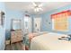Bedroom featuring blue walls, wood floors, and ensuite bathroom access at 9266 Sw 91St Cir, Ocala, FL 34481