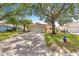 Inviting home featuring a spacious driveway and mature trees offering ample shade at 9266 Sw 91St Cir, Ocala, FL 34481
