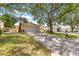 Attractive home with well-manicured lawn and mature trees lining the driveway at 9266 Sw 91St Cir, Ocala, FL 34481