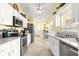 Well-lit kitchen with white cabinets, stainless steel appliances, and a granite countertop at 9266 Sw 91St Cir, Ocala, FL 34481