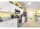 Bright kitchen features stainless steel appliances and a modern granite countertop at 9266 Sw 91St Cir, Ocala, FL 34481