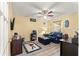 Inviting living room with a leather couch, golf decor, and wood-look flooring at 9266 Sw 91St Cir, Ocala, FL 34481