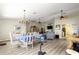 Open-concept living area with wood flooring, ceiling fans, and views of the dining and kitchen areas at 9266 Sw 91St Cir, Ocala, FL 34481