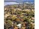 Aerial view showcases the home's location surrounded by lush trees and near the lake at 9330 Se 106Th Pl, Belleview, FL 34420