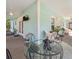 Spacious back porch with teal accents, ceiling fans, and an outdoor dining and living area at 9330 Se 106Th Pl, Belleview, FL 34420