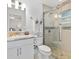Bathroom features modern shower with glass door, granite vanity and neutral tile at 9330 Se 106Th Pl, Belleview, FL 34420