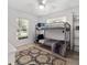 Well-lit bedroom with a bunk bed, neutral color scheme and simple decorations at 9330 Se 106Th Pl, Belleview, FL 34420