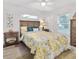 Cozy bedroom with wood furnishings, and a floral-themed comforter, offers a warm ambiance at 9330 Se 106Th Pl, Belleview, FL 34420
