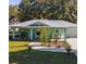 Charming teal home featuring a metal roof, inviting front porch, and well-maintained front lawn at 9330 Se 106Th Pl, Belleview, FL 34420