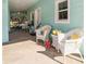 Relaxing front porch featuring wicker furniture, decorative pillows, and a welcoming ambiance at 9330 Se 106Th Pl, Belleview, FL 34420
