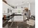 Modern kitchen featuring stainless steel appliances, dark countertops, and ample cabinet space at 9330 Se 106Th Pl, Belleview, FL 34420