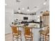 Bright kitchen featuring stainless steel appliances, dark countertops, and breakfast bar seating at 9330 Se 106Th Pl, Belleview, FL 34420