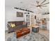 Bright living room featuring a brown sofa and an open floor plan connecting to the kitchen at 9330 Se 106Th Pl, Belleview, FL 34420