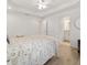 Bright main bedroom boasts en suite bathroom, white wood bed frame, and neutral decor at 9330 Se 106Th Pl, Belleview, FL 34420